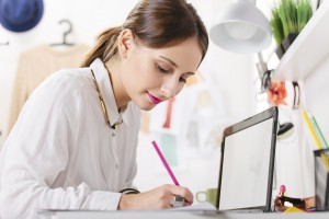 Fashion woman blogger working in a creative workspace.