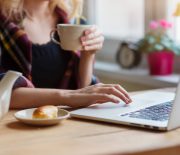 Beautiful woman relaxing at home with notebook and cup of  coffee
